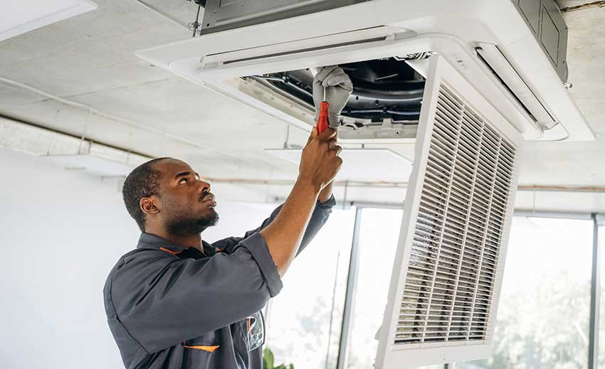 Technican inspecing ductwork before making a decision about duct cleaning